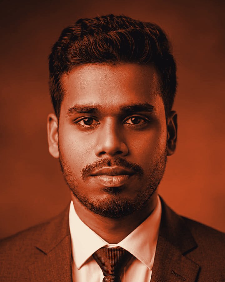 Md. Fazle Rabbi in a dark suit and navy tie
